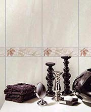 Beige tiles with listello behind candlesticks